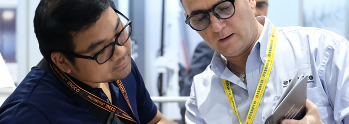 Image of a man showing another man something on a brochure